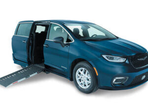 The Chrysler Pacifica minivan features an extended wheelchair ramp from the passenger side, showcasing excellent accessibility features.